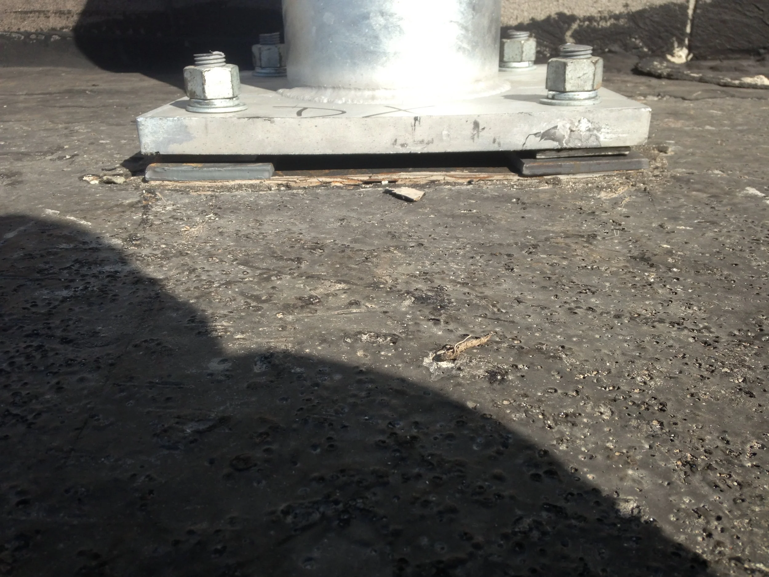 Step 2. Hole locations were marked using the template, then all four holes were drilled from the roof down for insertion of the through bolts.