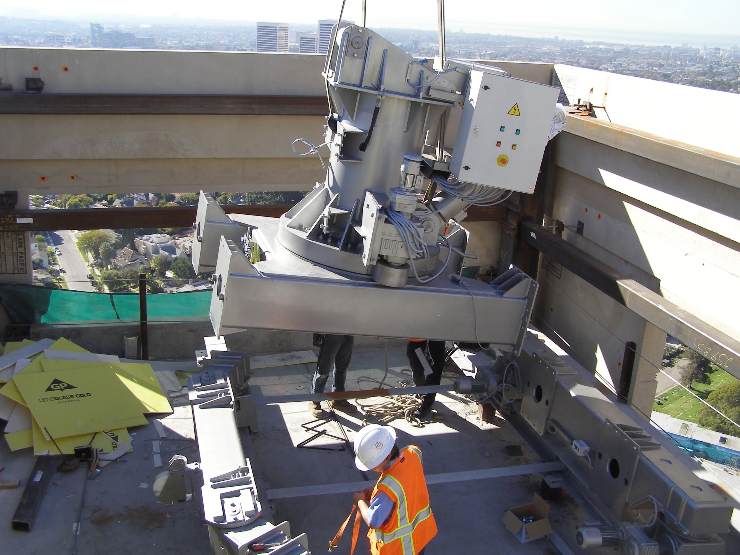 Step 5. Shown here is the base being lowered between the two motorized wheel assemblies where they will be bolted together.