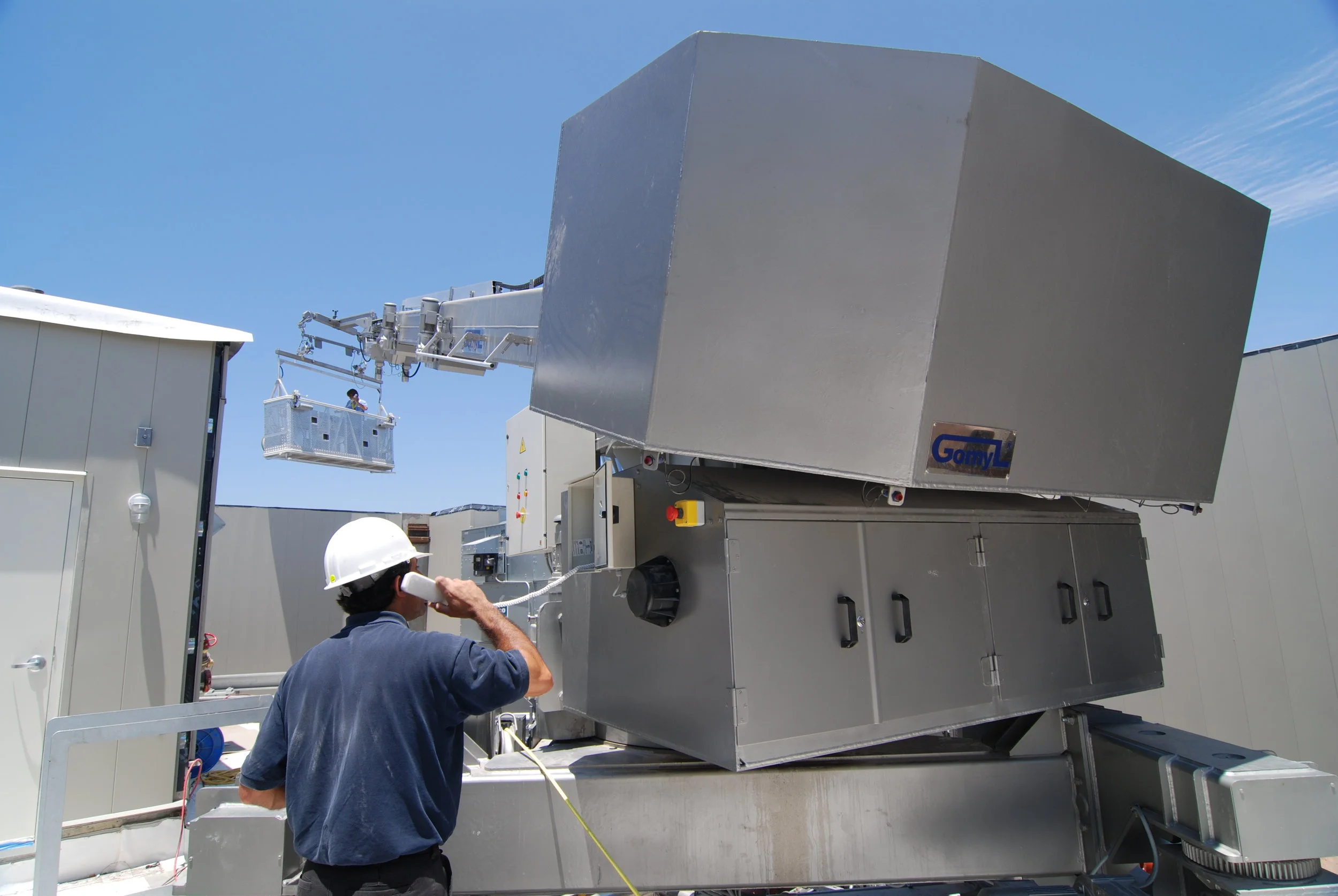 Step 9. BMU traveling under the Helipad from East to West side of the building. Two operators are necessary to adjust for tight clearances.