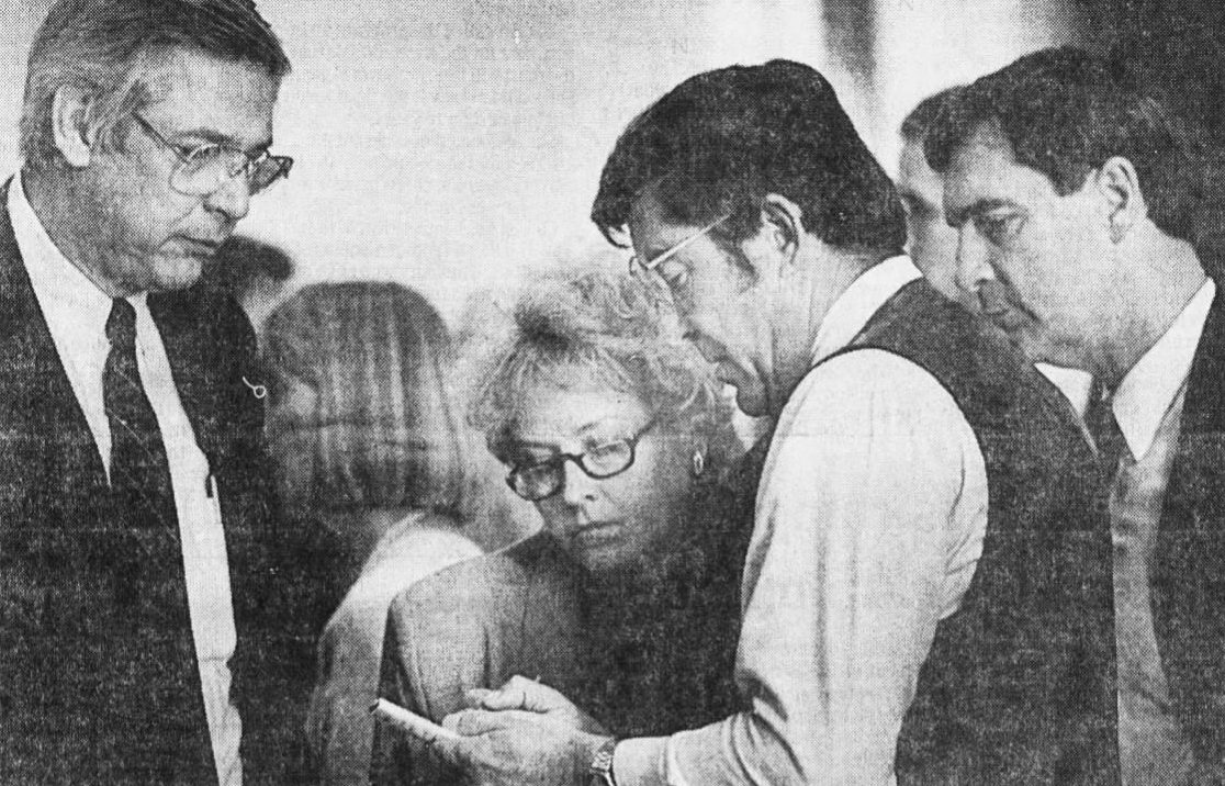 During debate on the logo signs bill in 1988, billboard industry lobbyists Bill Bruce and Felicia Carson (left) confer with Rep. Frank Buck (D-Smithville) and Rep. David Ussery, R-Clarksville. Carson's firm later won the contract to market and manage the logo signs. Photo credit Bob Roller, The Tennessean