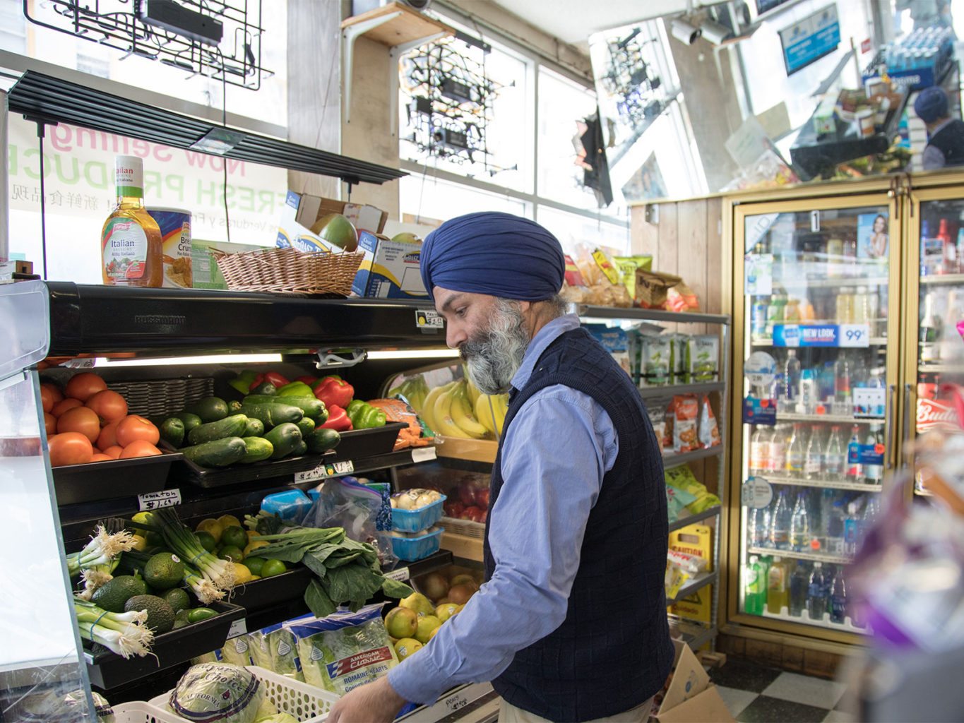 Satwinder “Bill” Multani, owner of Daldas Groceries and Delicatessen in the Tenderloin, organizes the fresh produce in his store on Wednesday, May 10, 2017. (Steven Ho/Special to S.F. Examiner)
