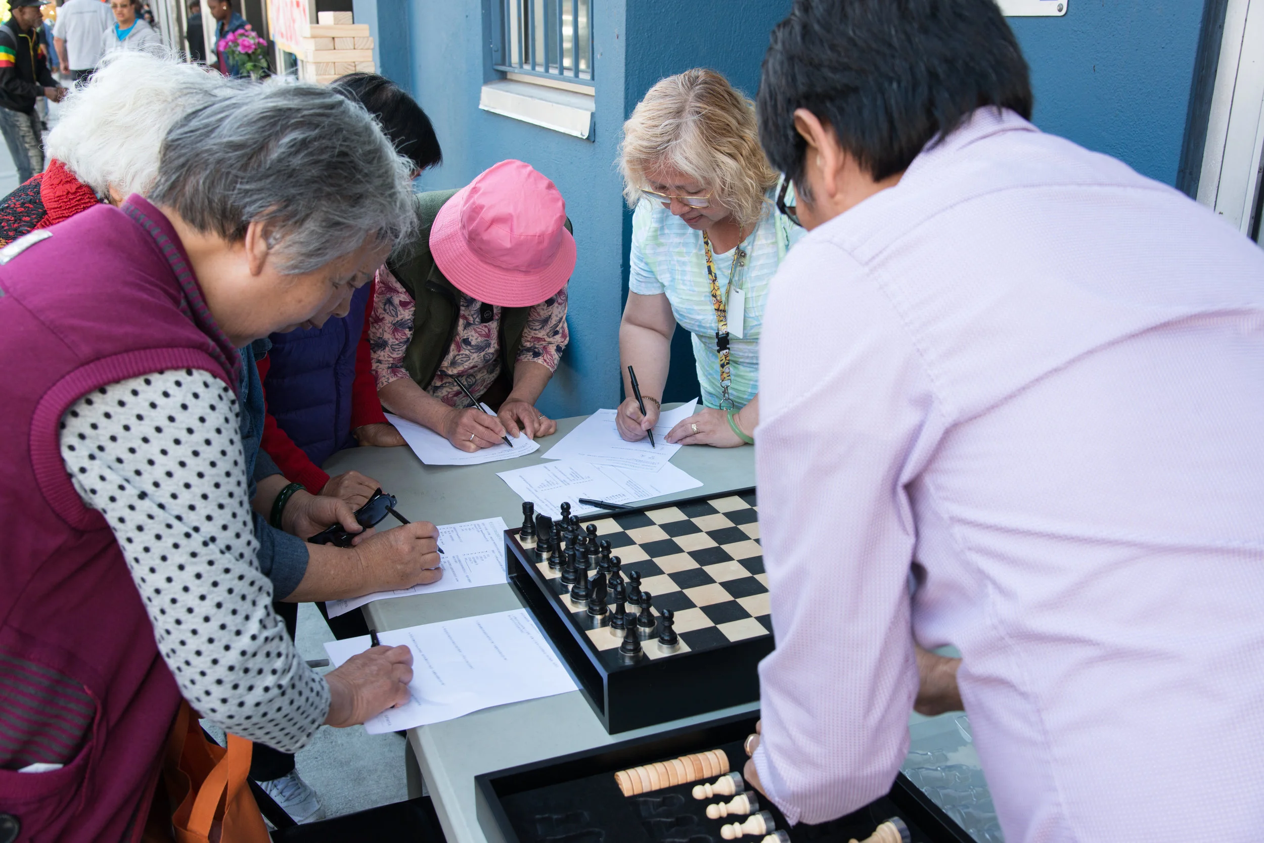 Tenderloin neighborhood residents provide feedback on surveys for the Safer Taylor Street Project during a community pop-up event and worksop on Taylor Street in August. Photo: SFMTA 