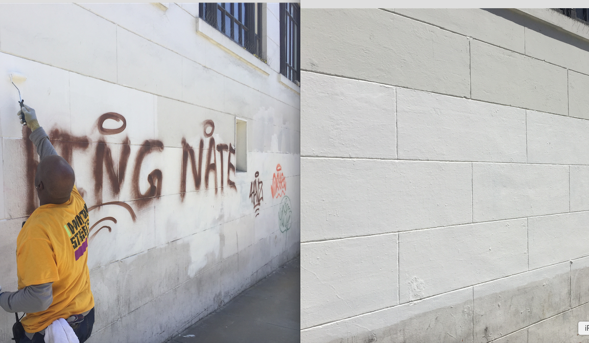 DST team member Michael removes graffiti from a building at Ellis and Leavenworth.