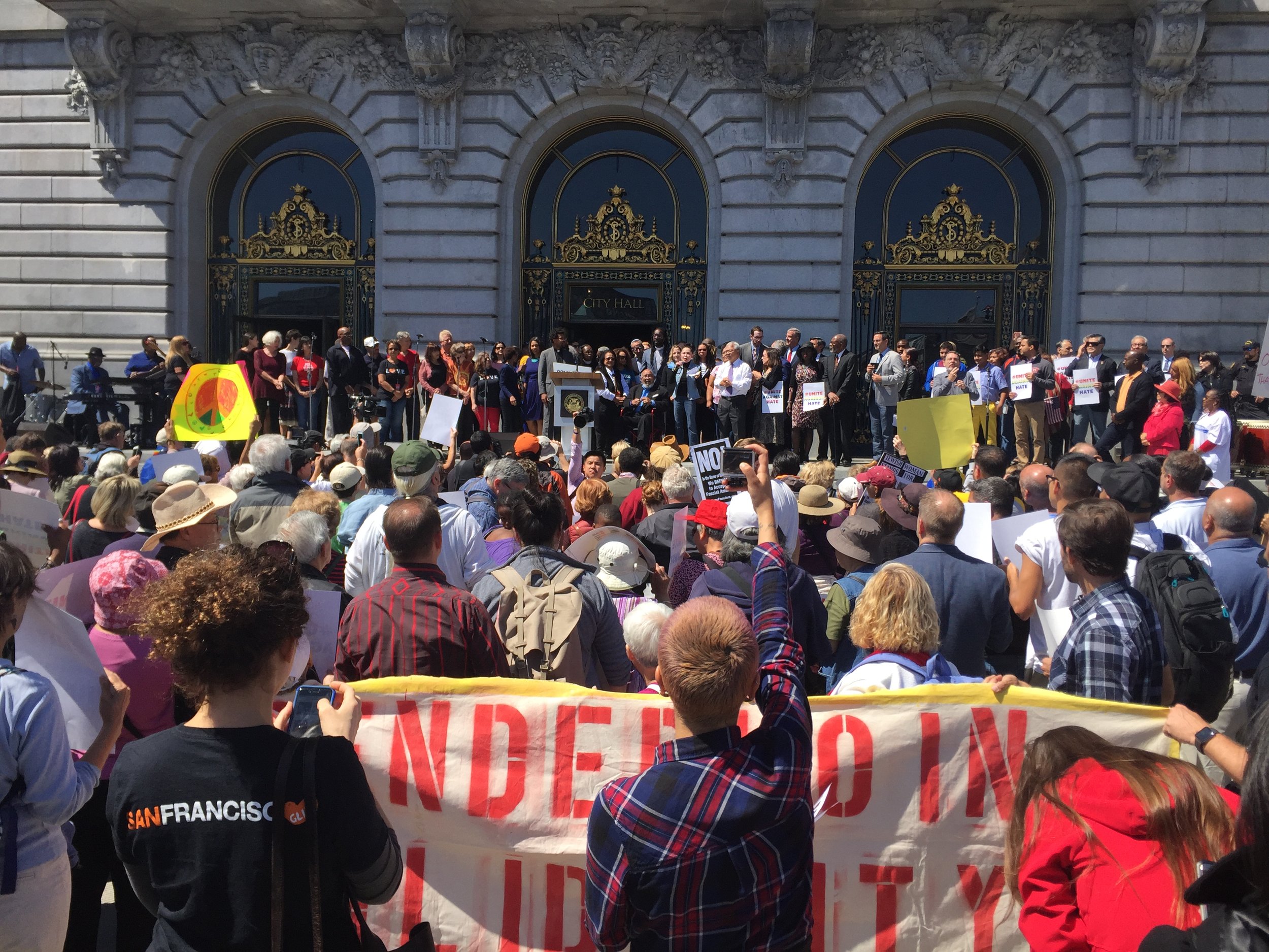 Photo: &nbsp;GLIDE clergy and leadership including founders Cecil Williams and Janice Mirikatani rally on the steps of City Hall with late Mayor Ed Lee to show support for immigrants amongst threats to sanctuary cities from Trump administration.