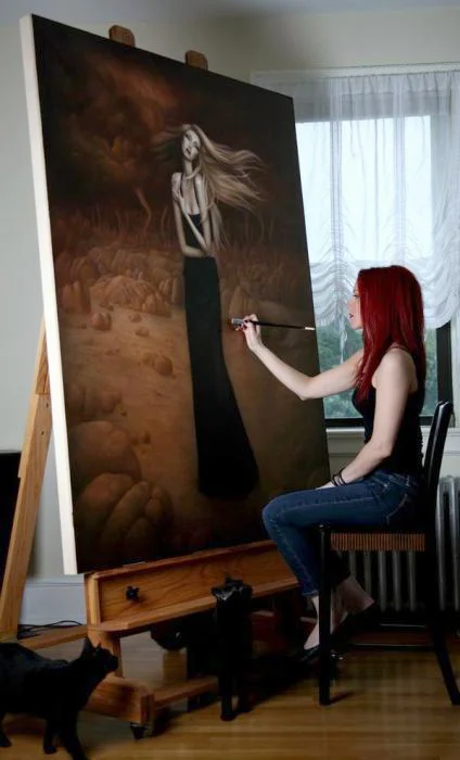 Lori Earley painting The Pinnacle , 2008 with kitties Jade and Dez.