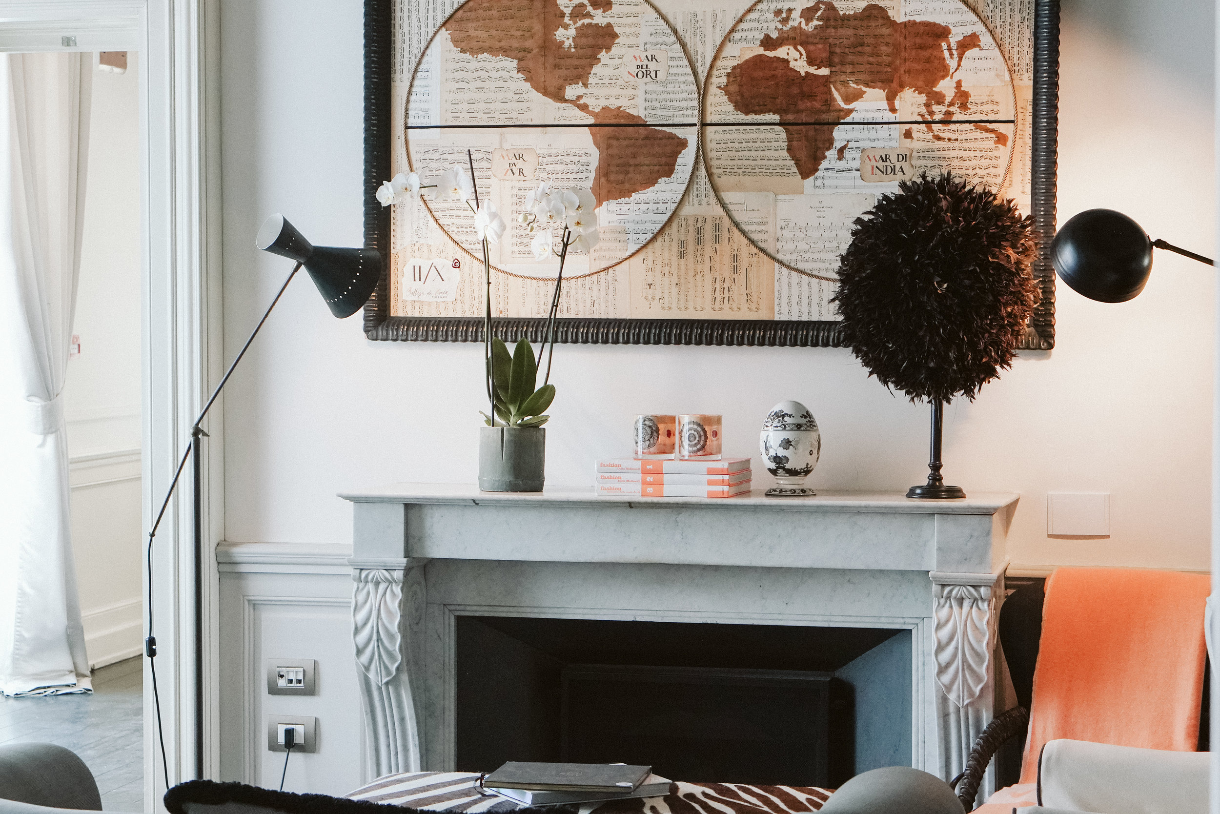 The Salon is full of eclectic collection of unique pieces. On the Charles X fireplace the feathered headdress of a chief tribesman, from Zaire. Art Deco pouf in zebra skin and a lamp from the 1950s.