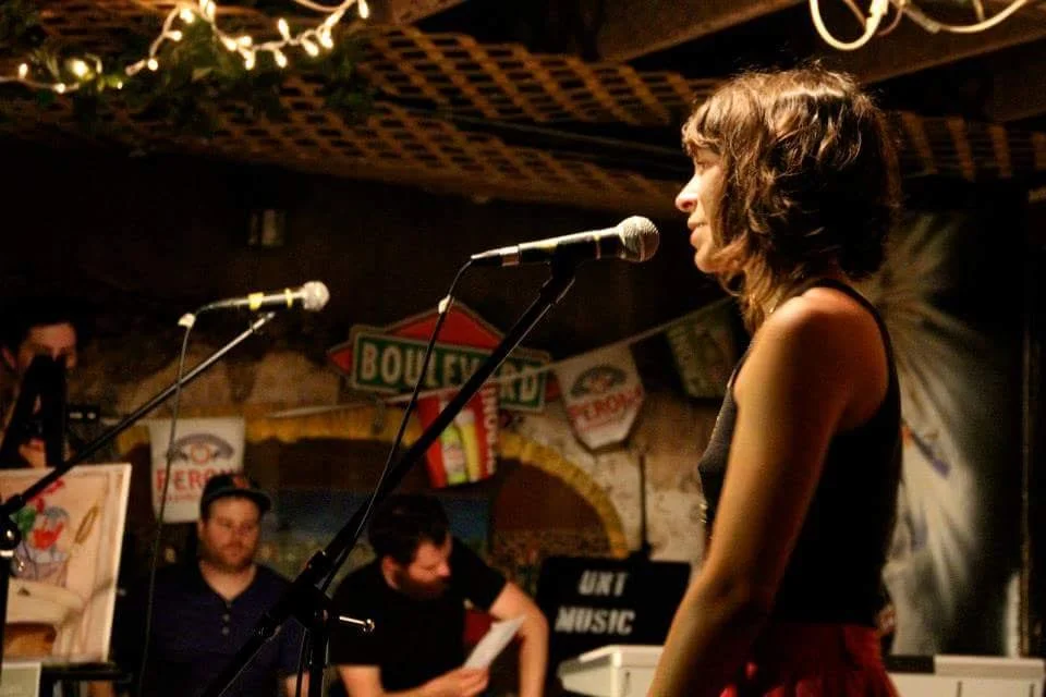 Marie DeNoon reading at a spiderweb showcase in J&Js basement | photo by courtney marie | 2013