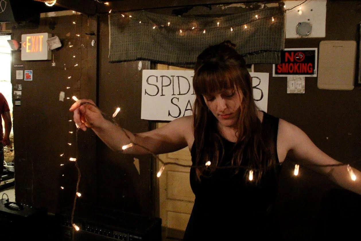 Bess Whitby setting up for spiderweb salon's first electronic experiment show | photo by courtney marie | 2014