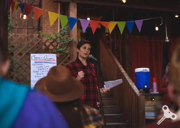 Logen reads at Spiderweb’s Cheers for Queers event in 2018. Photo by Saraphim Art