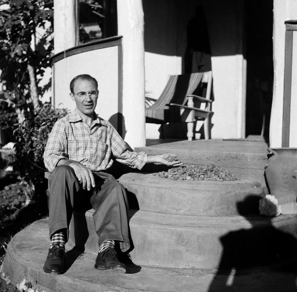 1952 Queensland, Australia. Harry Kazanjian sitting adjacent to blue and black sapphire rough at the Spencer Home. This is the same location a few year after where Harry found the world renowned "733 carat black star sapphire of Queensland." 