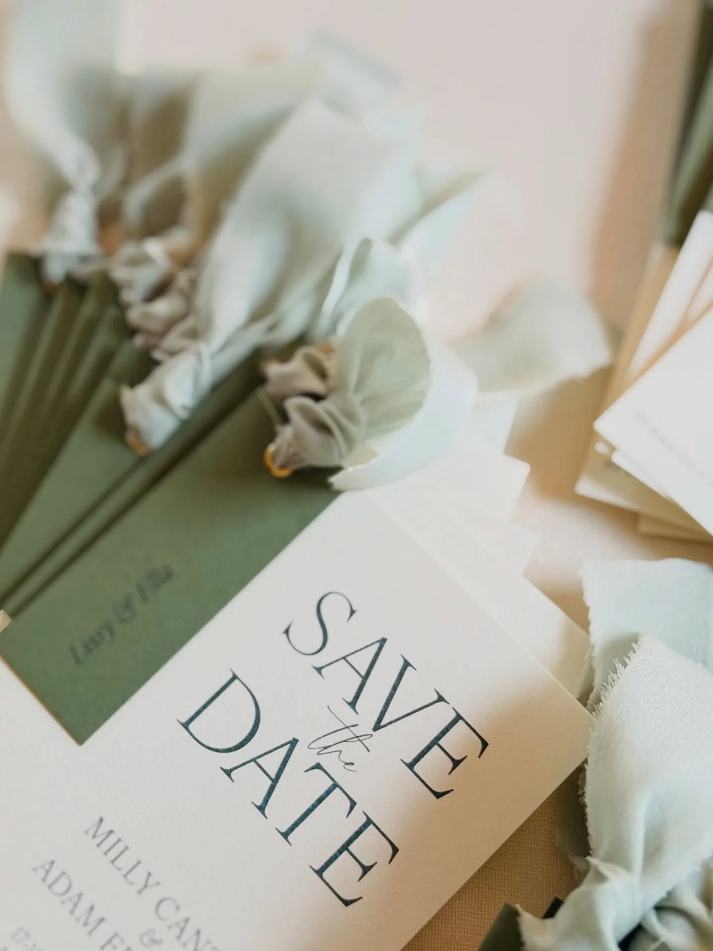 Personalised Save the Dates for 2026 destination weddings, featuring olive green details and silk sage ribbons. Give your guests essential advance notice to plan travel and accommodation before your formal wedding invitations are sent 💌