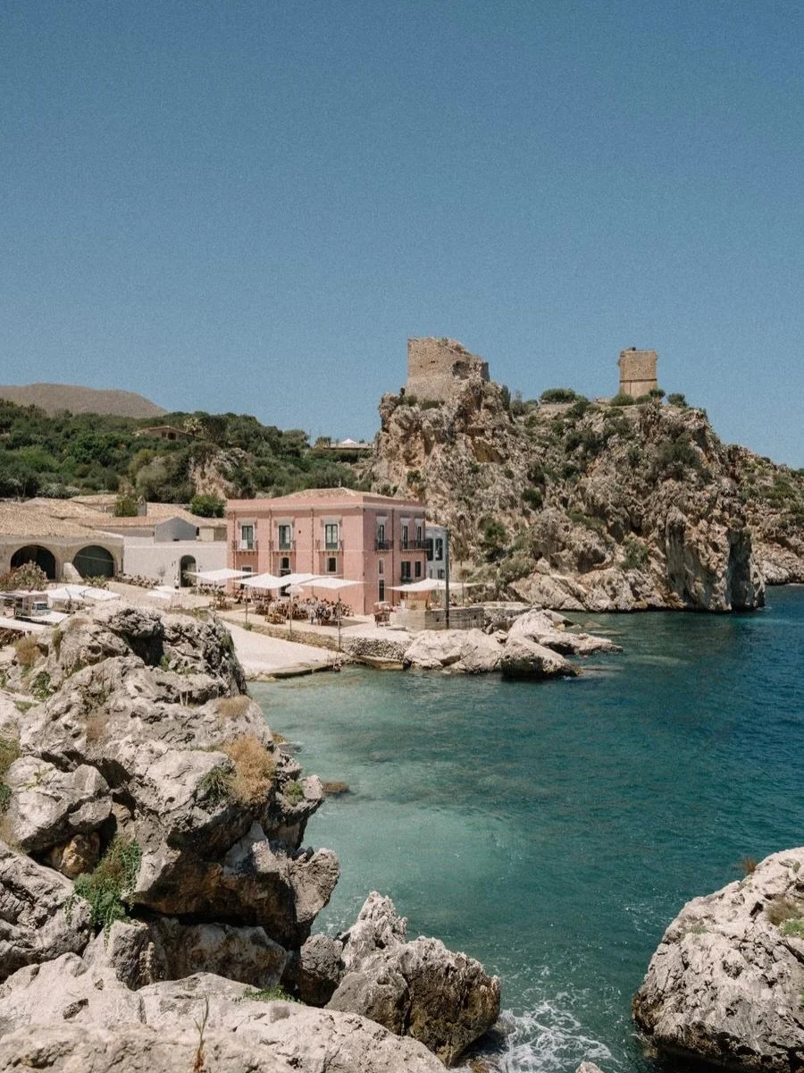 Picturesque, tranquil and oozing old fashioned romance, Tonnara di Scopello was the perfect location for Filda and Steve&rsquo;s wedding celebration. Candlelit tables, soft drapes paired with chocolate brown accents, and the most incredible bow-cover