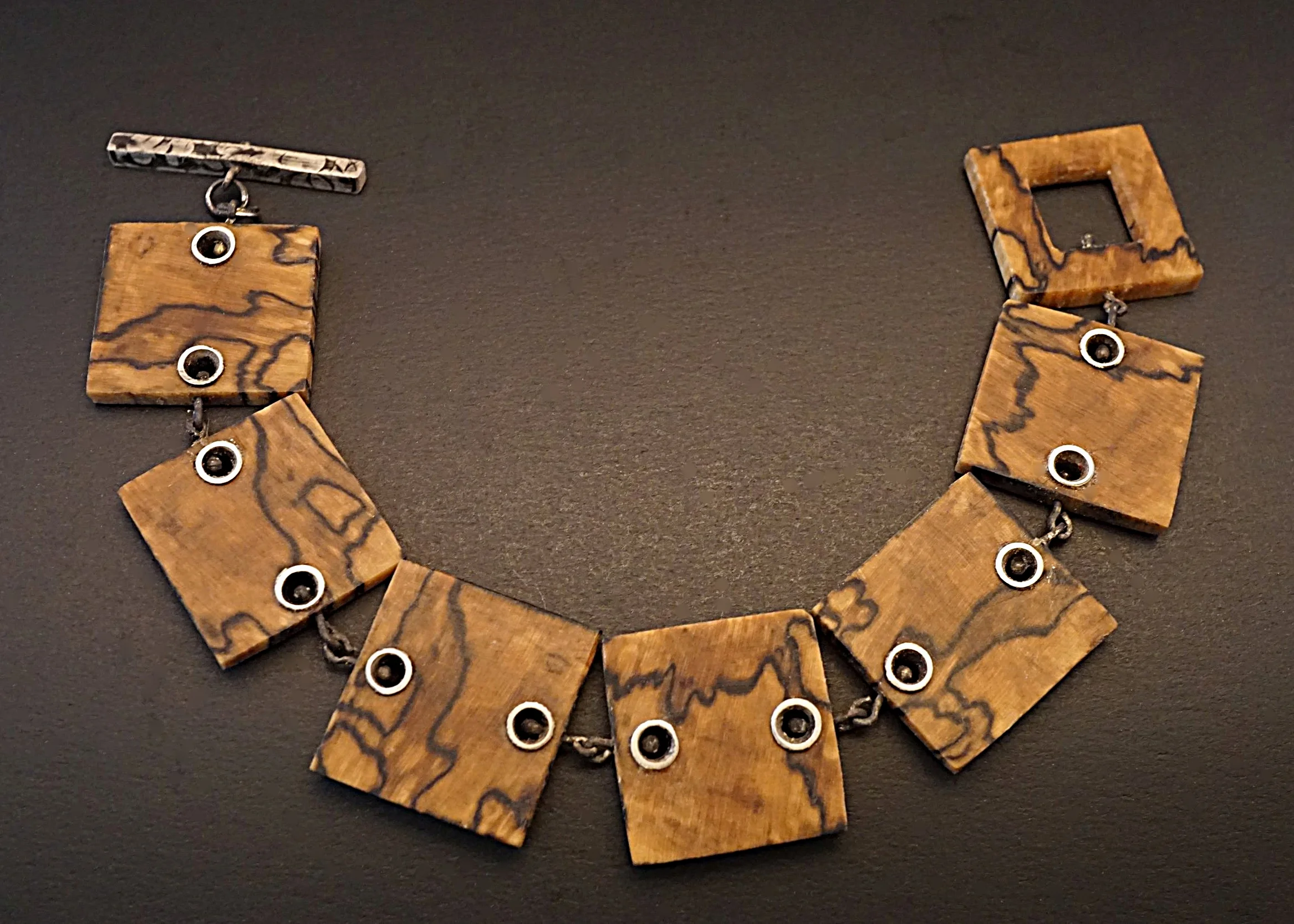 Hand carved spalted hackberry wood links with sterling silver rivets, links, and toggle