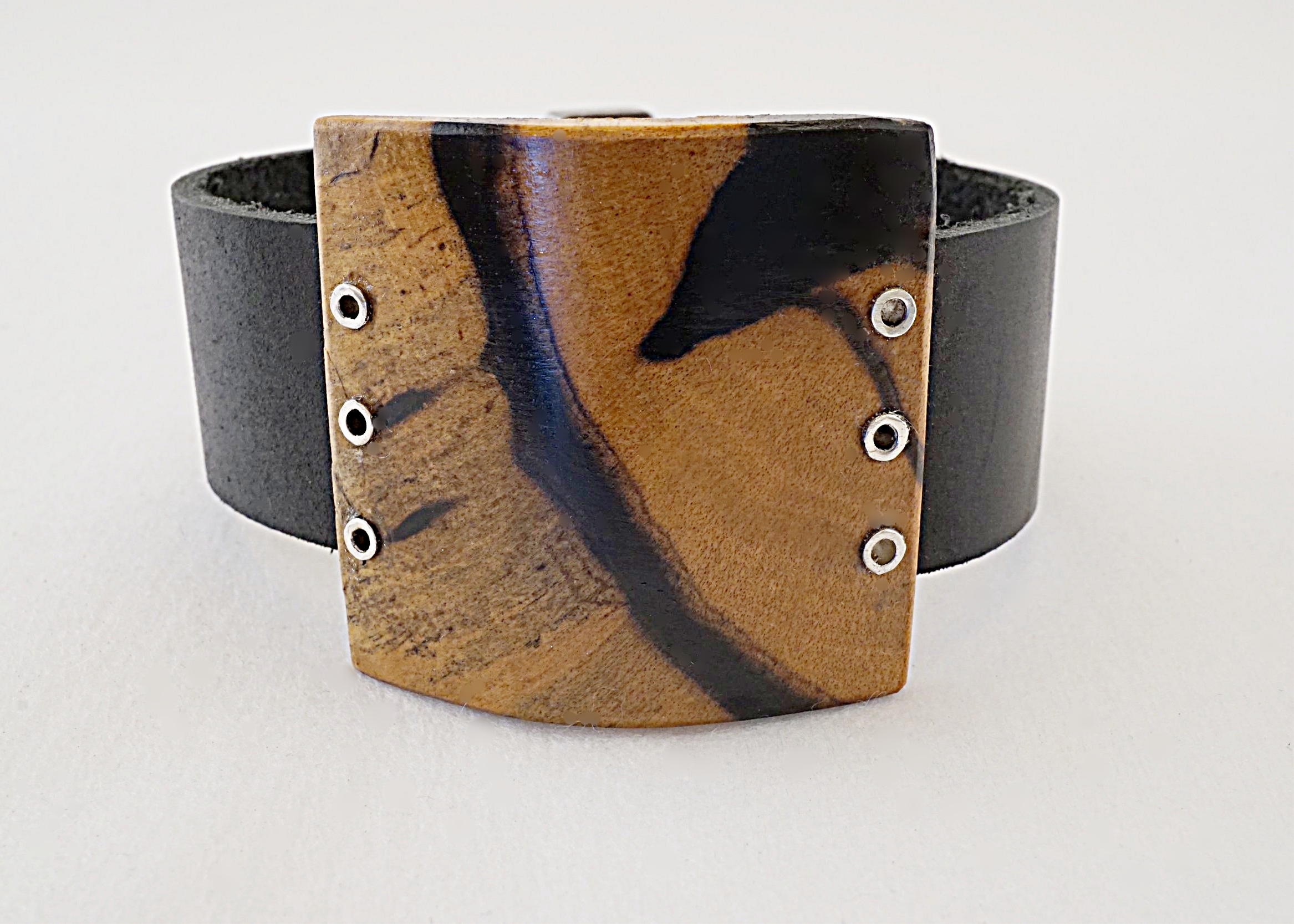 Black and white ebony wood with sterling silver rivets with black leather strap