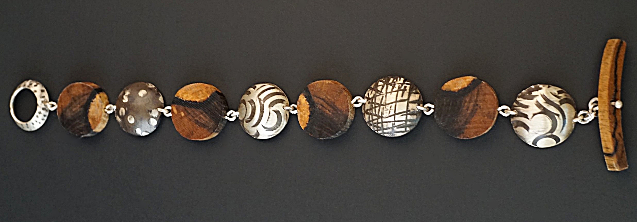 Hand carved black and white ebony wood links rotating with sterling silver hand stamped and domed links