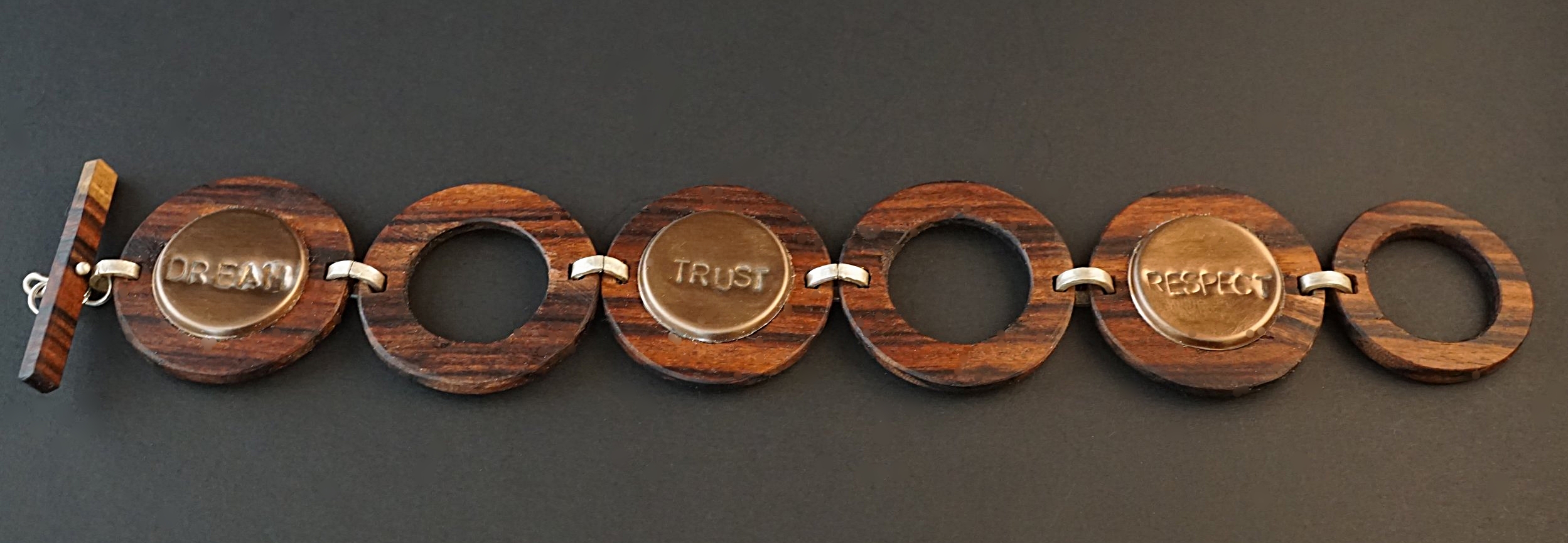 Bolivian Rosewood with hand stamped copper color tiles. Hand stamped with dream, trust, respect, family, faith, create