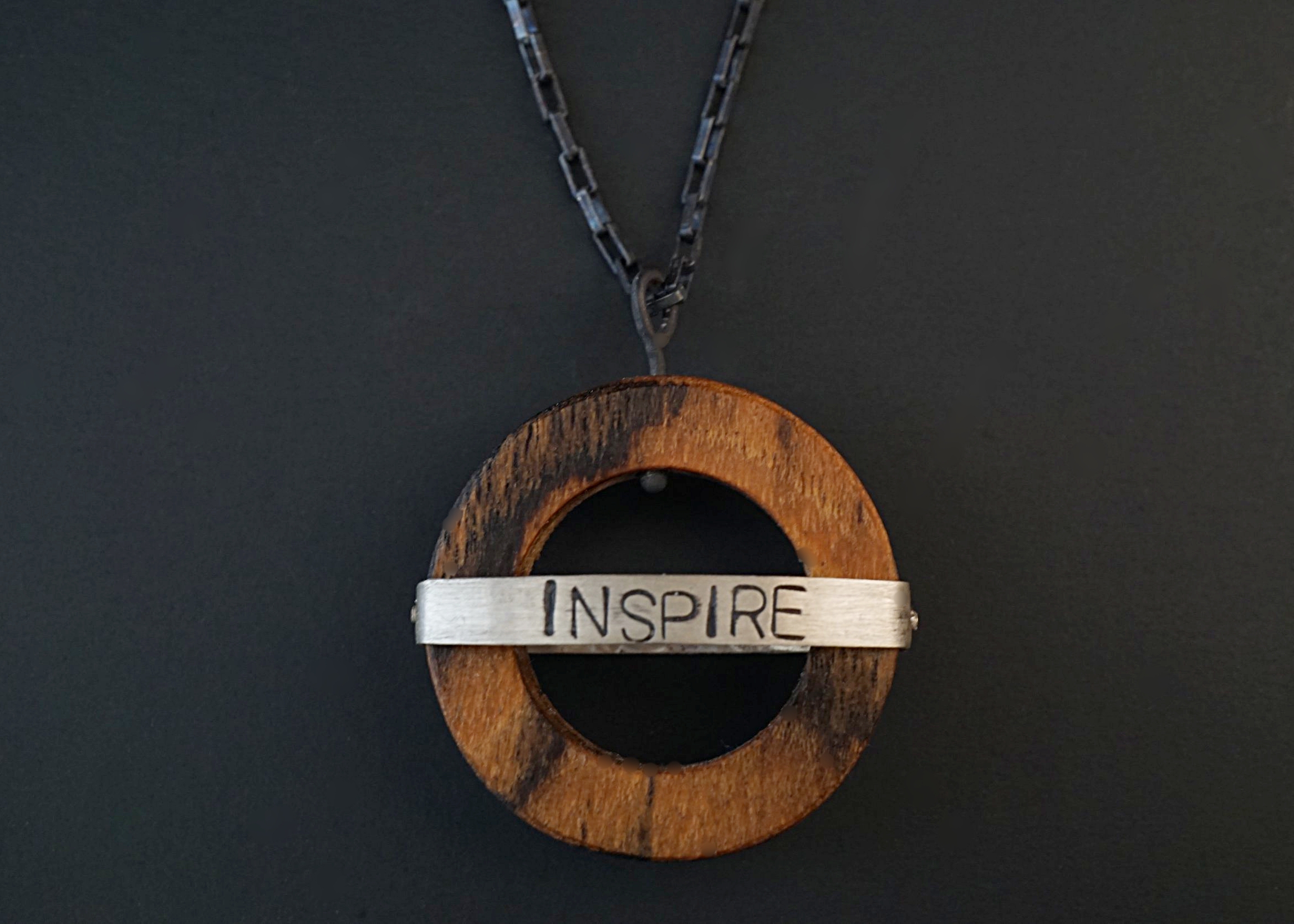 Bocote circular pendant with hand stamped sterling silver inspire