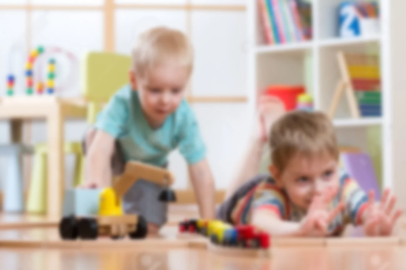53851923-Children-play-with-wooden-train-and-build-toy-railroad-at-home-or-daycare-Stock-Photo.jpg