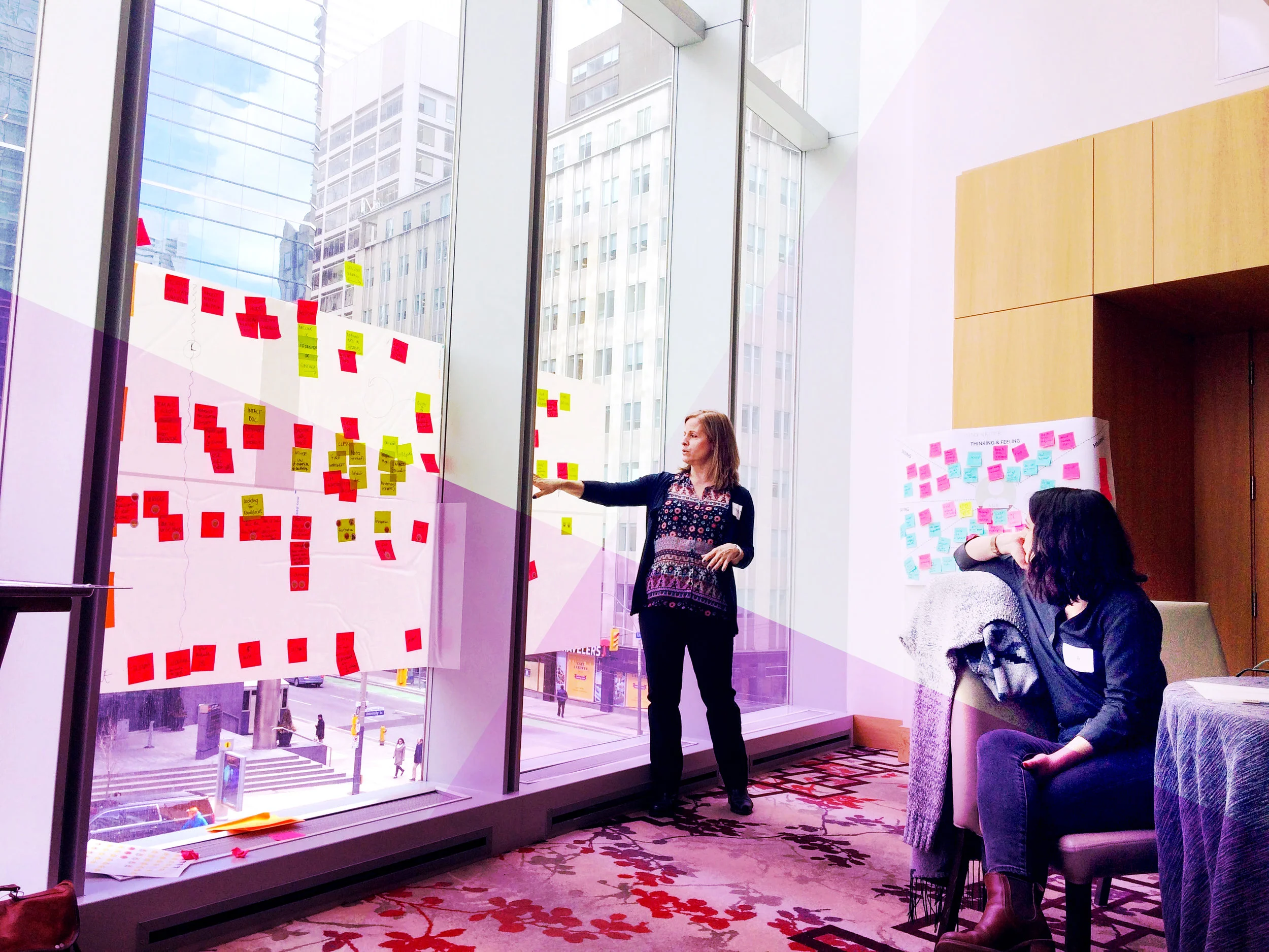 two-people-talking-about-post-its-in-workshop.jpg photo by simon vinh