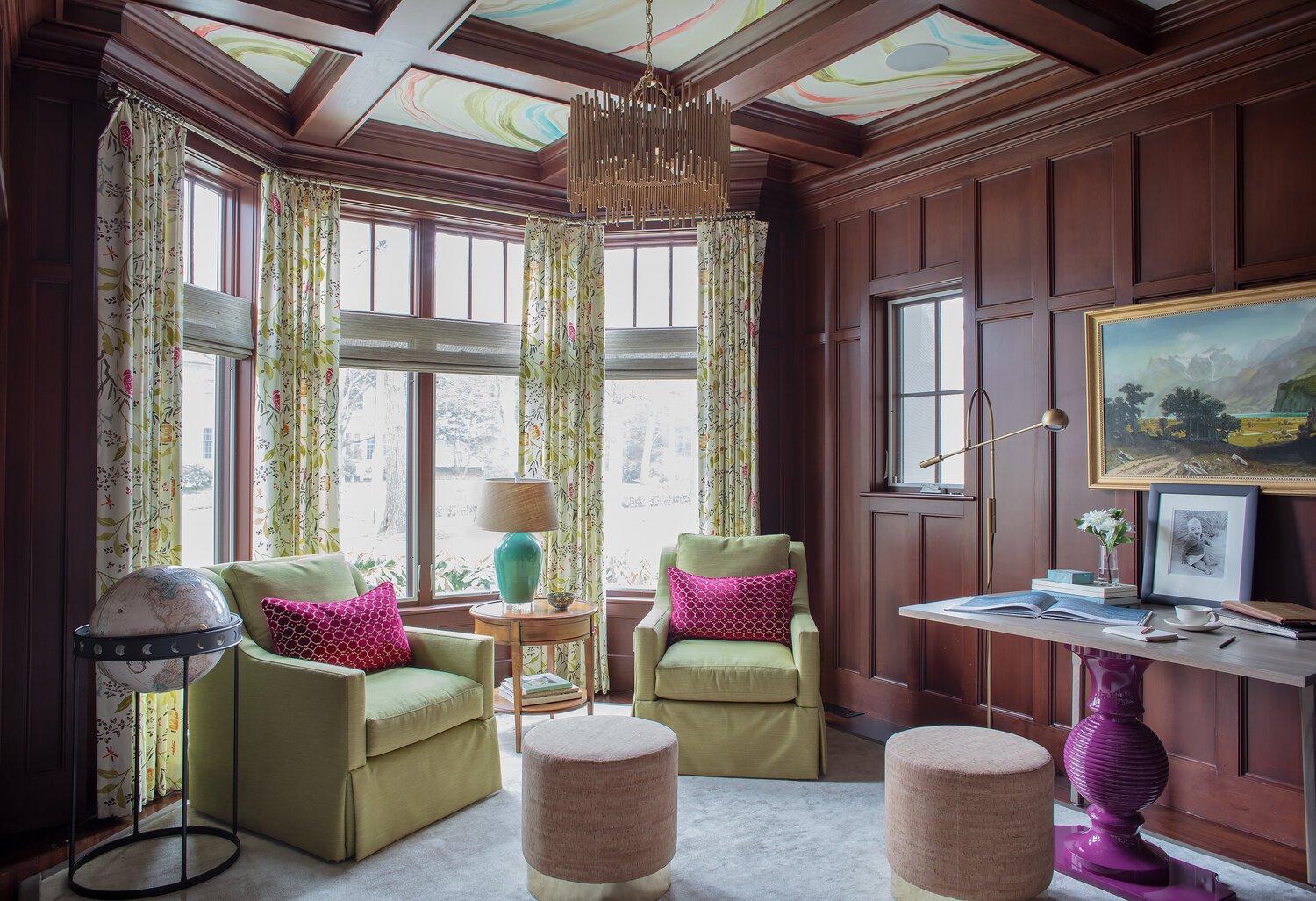 I'm absolutely in love with the way the blend of warm, natural woods and timeless millwork forms a striking contrast with vibrant hues of lime green, plum, and fuchsia. Traditional artwork on a modern table, a standout chandelier, and organic texture