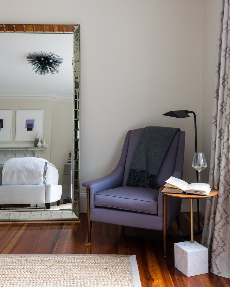 Every bedroom deserves a cozy corner for unwinding, don't you think? I absolutely adored incorporating this vintage mid-century armchair, which was refurbished in plush wool sateen in the most perfect shade of muted violet, to enhance the snug and in