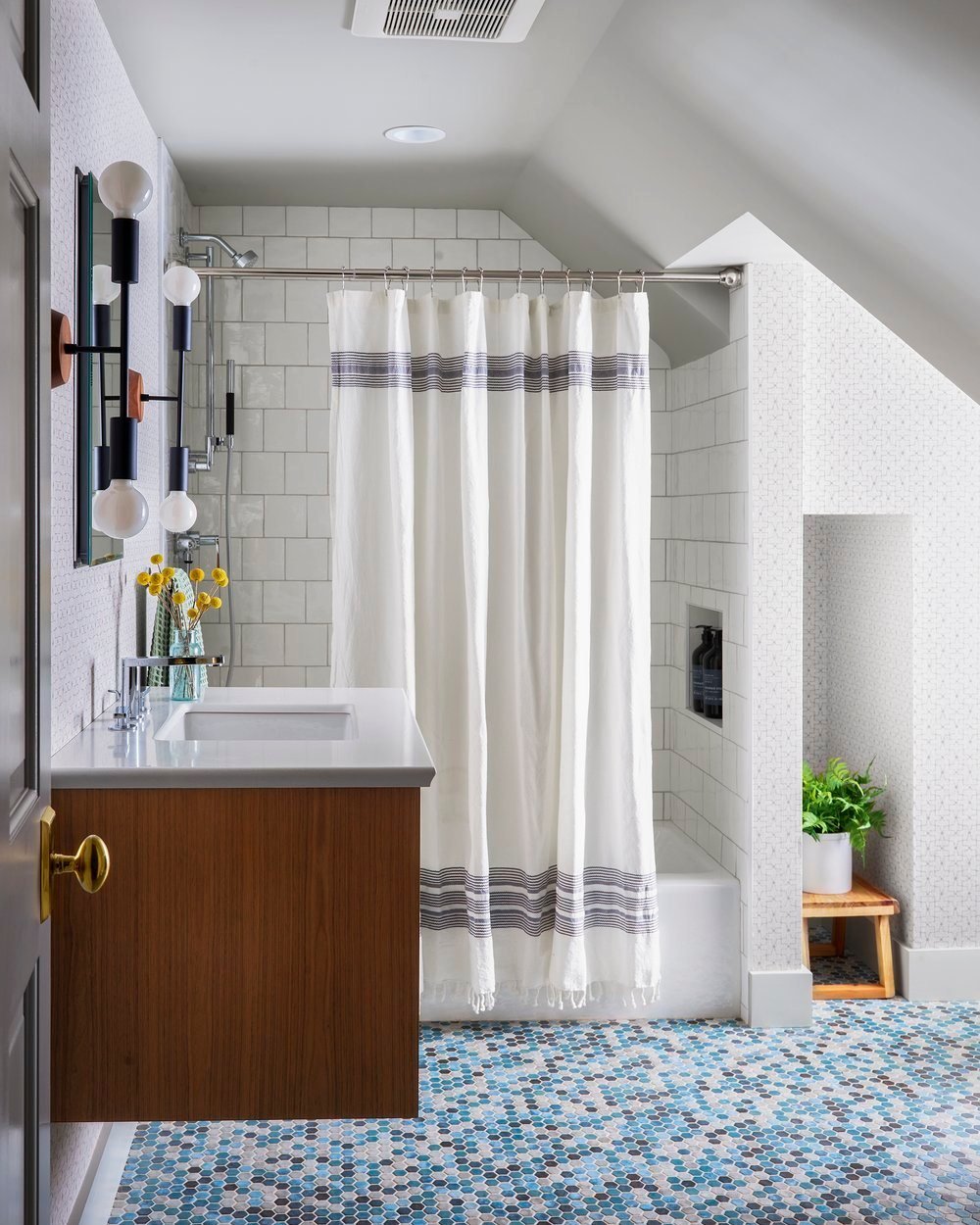 I can't help but love the elegance of a clean, classic bathroom, but that doesn't mean it has to be entirely white. The staying power of subway tiles transcends trendiness, and they pair beautifully with the vibrant mosaic floor. To add another layer