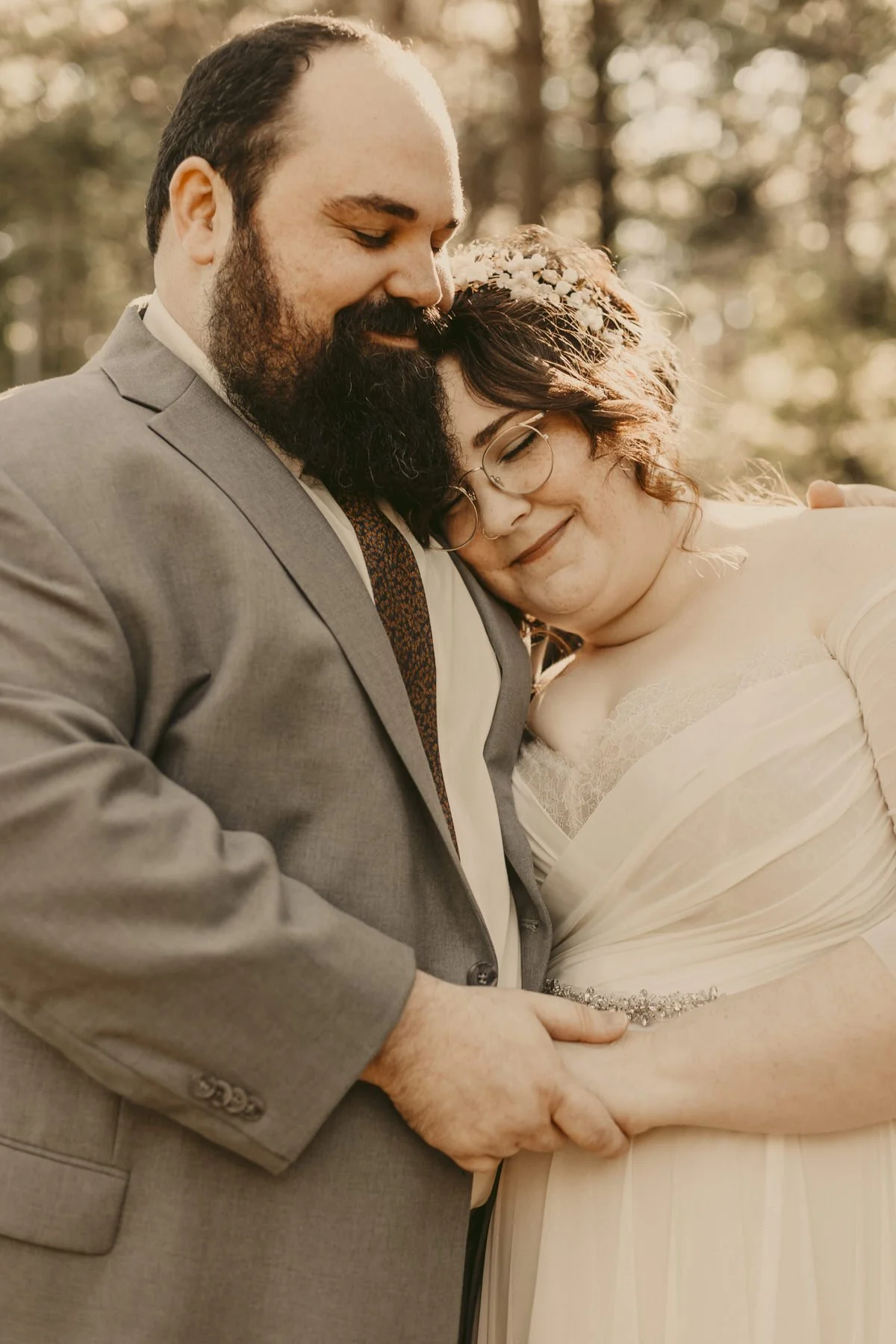 Couple embracing in forest on their Kohler Andrae State Park Elopement