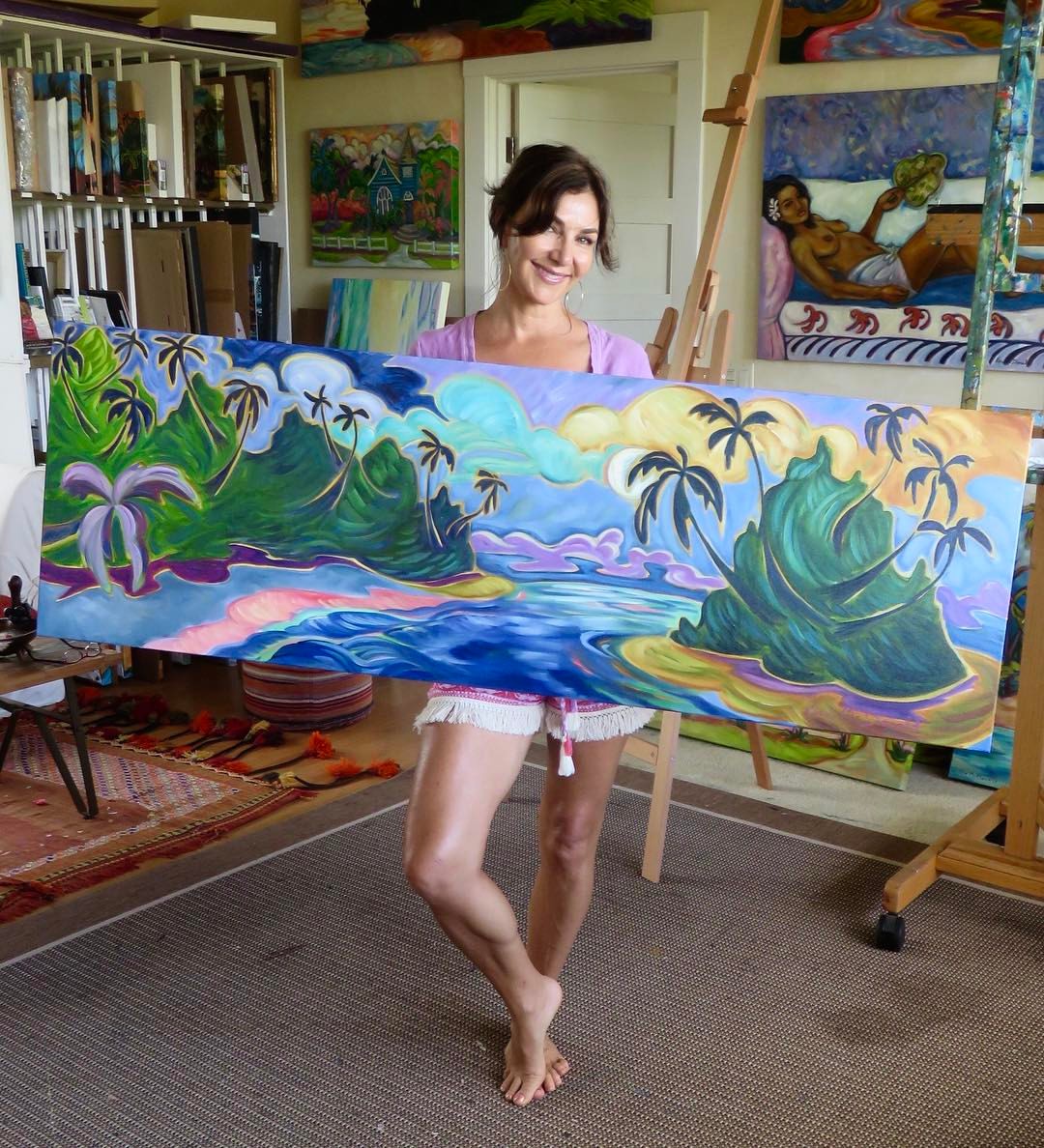 Kim McDonald posing with one of her wide art pieces
