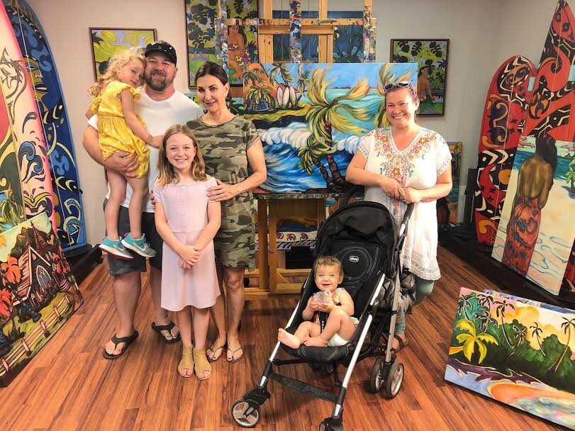 Family posing at Kim McDonald's gallery