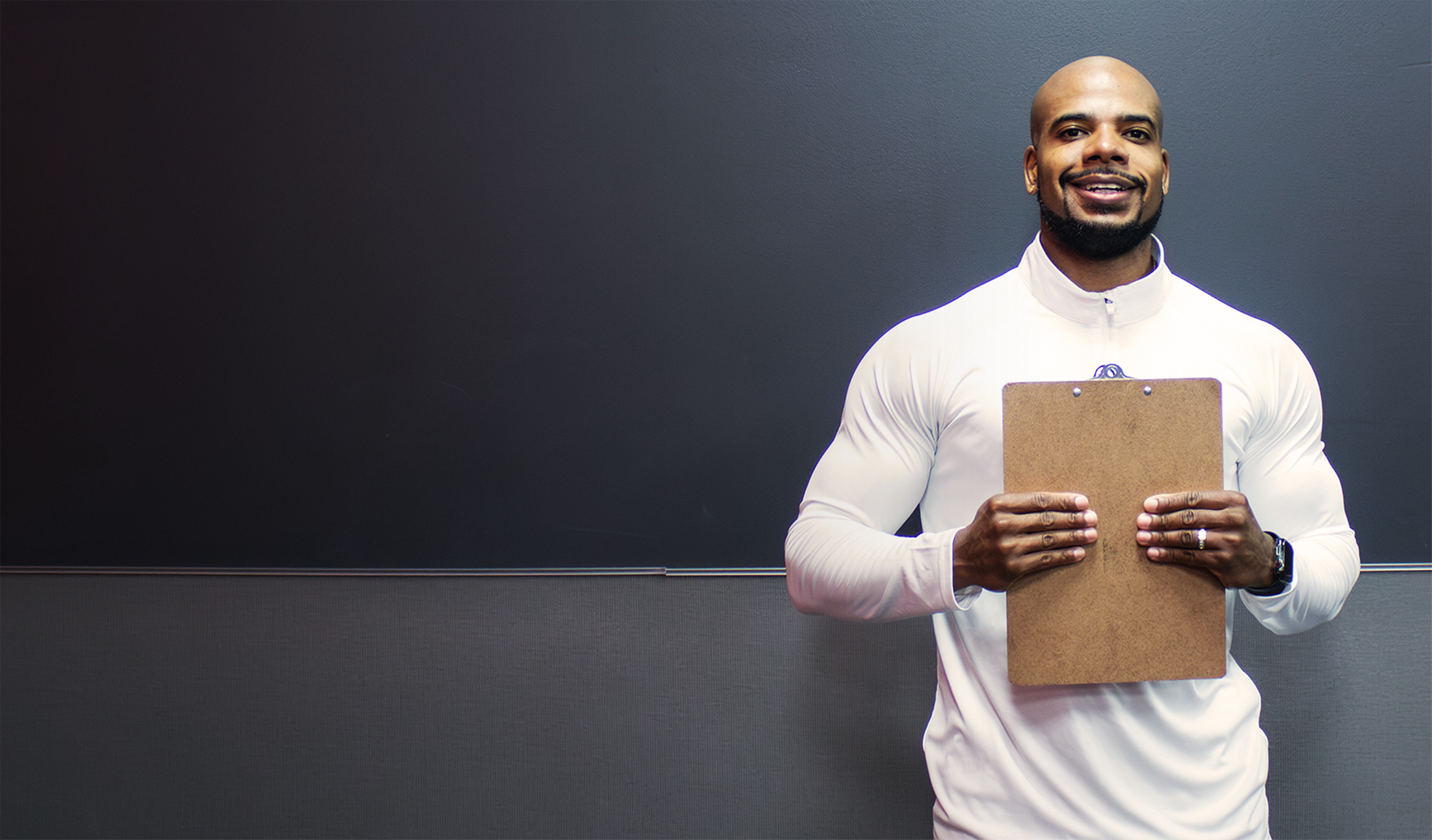 Muscular man holding a clipboard