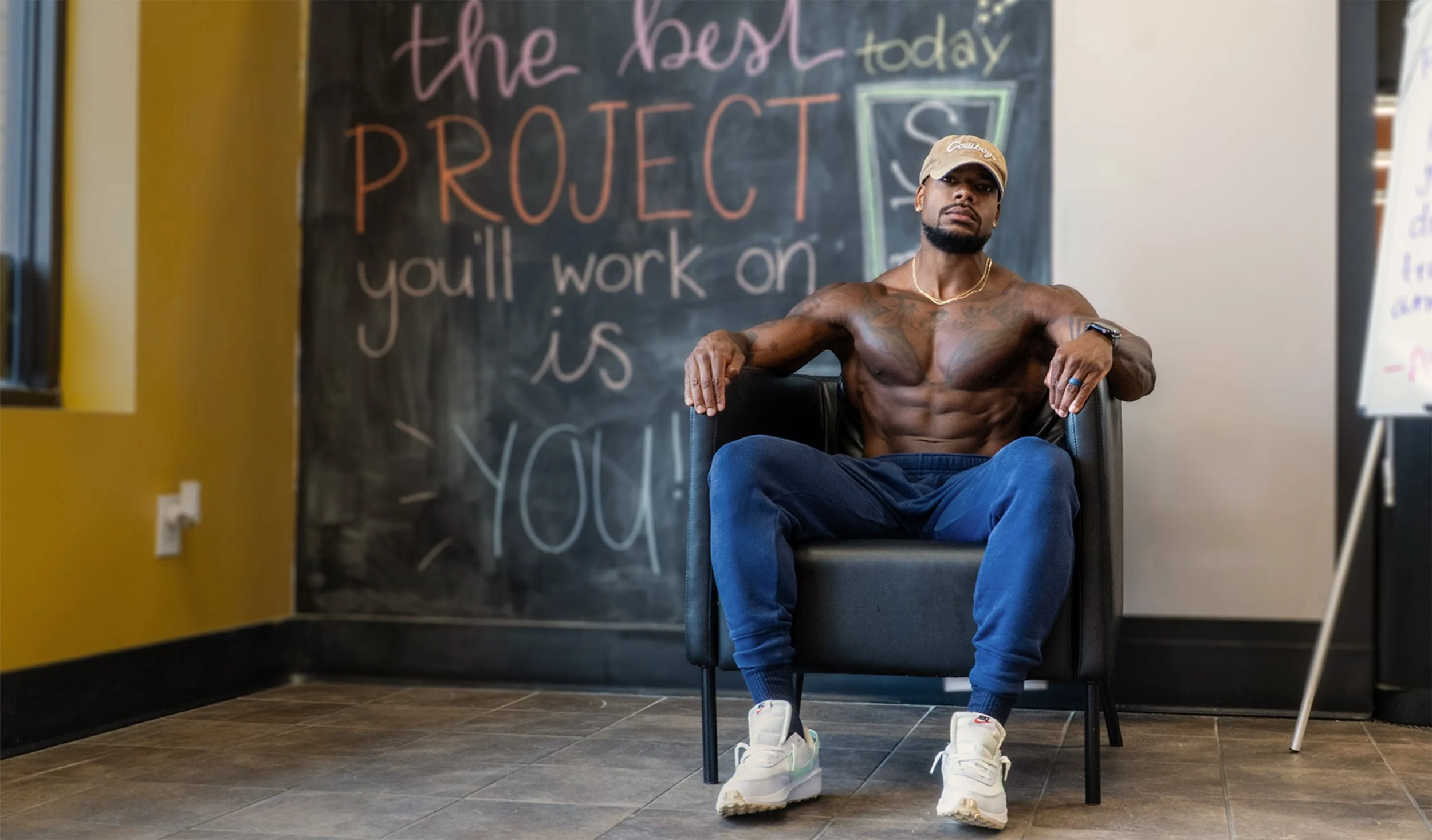 Muscular man sitting on A CHAIR