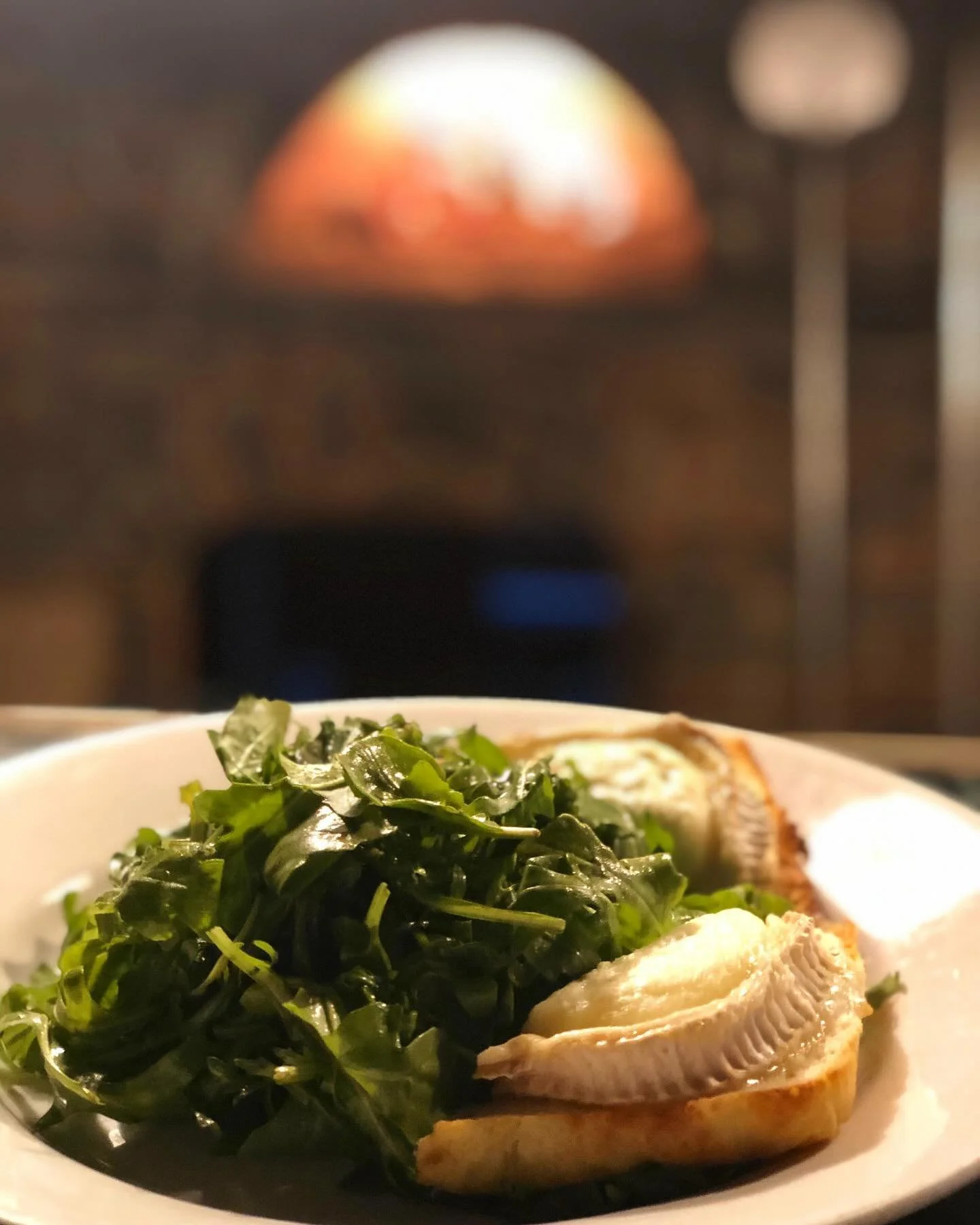 Warm Goat Cheese Salad 😍

Arugula tossed with balsamic + our house made focaccia bread toasted in the wood fired oven with Cana de Cabra goat cheese