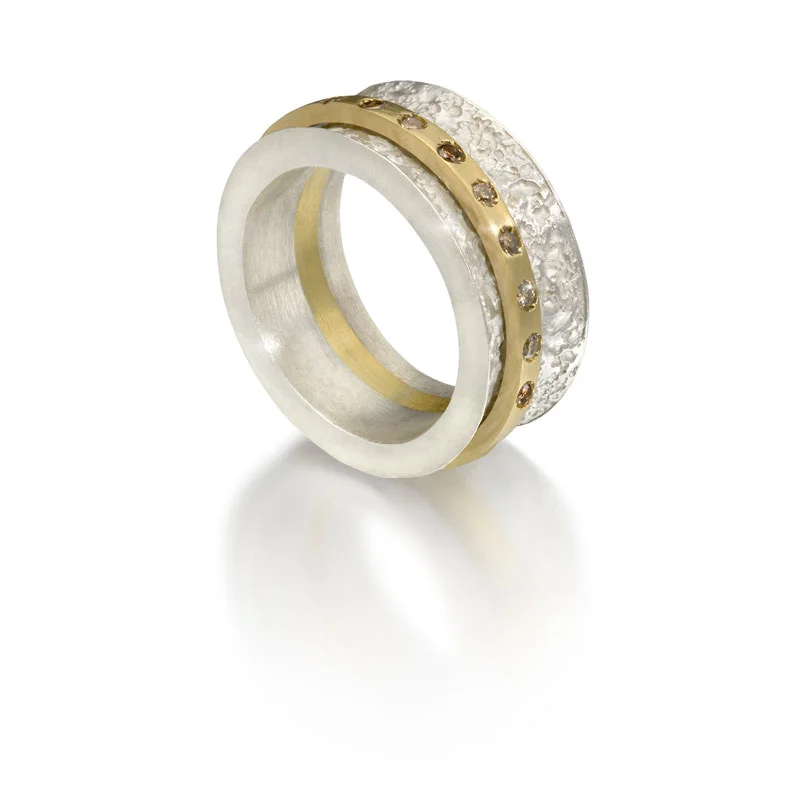 Etched silver outer ring with 18ct gold moving inner ring with cognac diamonds