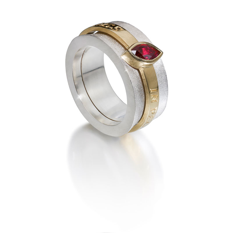 Silver outer ring, 18ct gold inner ring with ruby and engraving in latin ‘In the heart I trust’