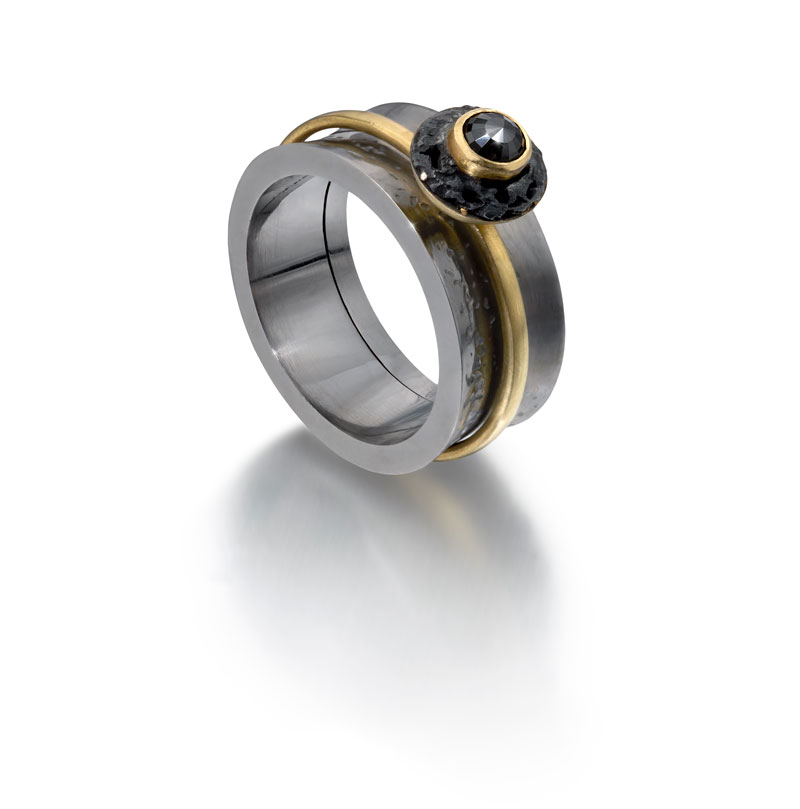 Black rhodium plated silver outer ring, 18ct gold inner ring with black diamond