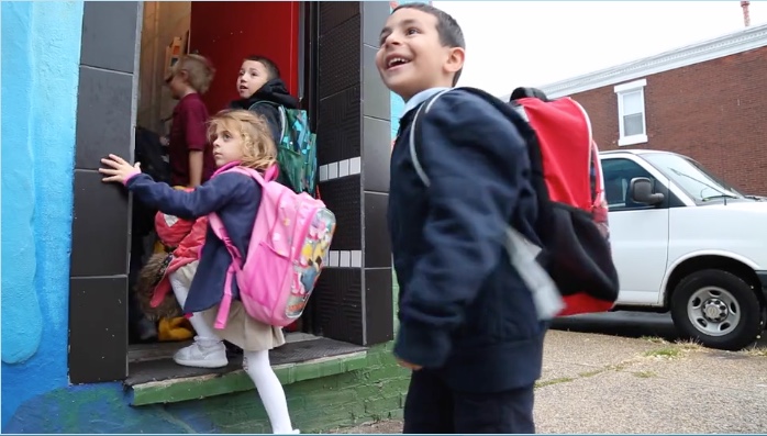 Children happily running into class.