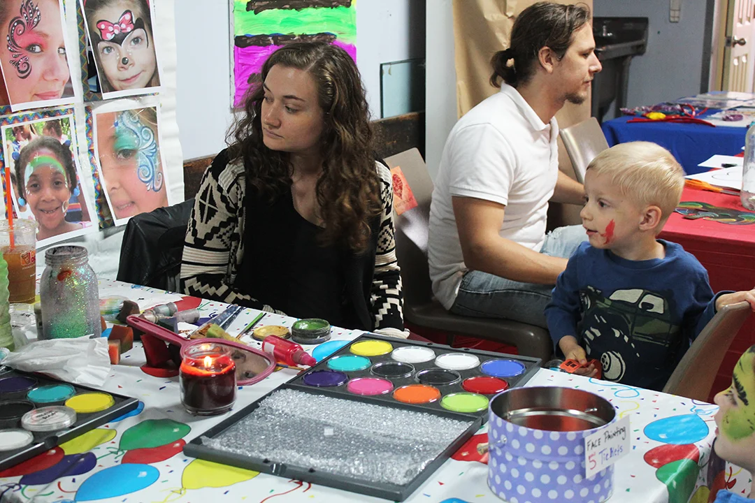Sarah Damiano showing a young student face painting!