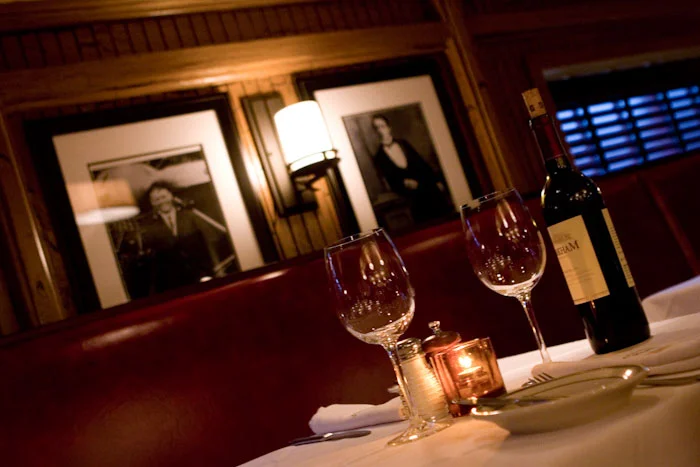 An interior photo of a table at Strip Steak with two wine glasses