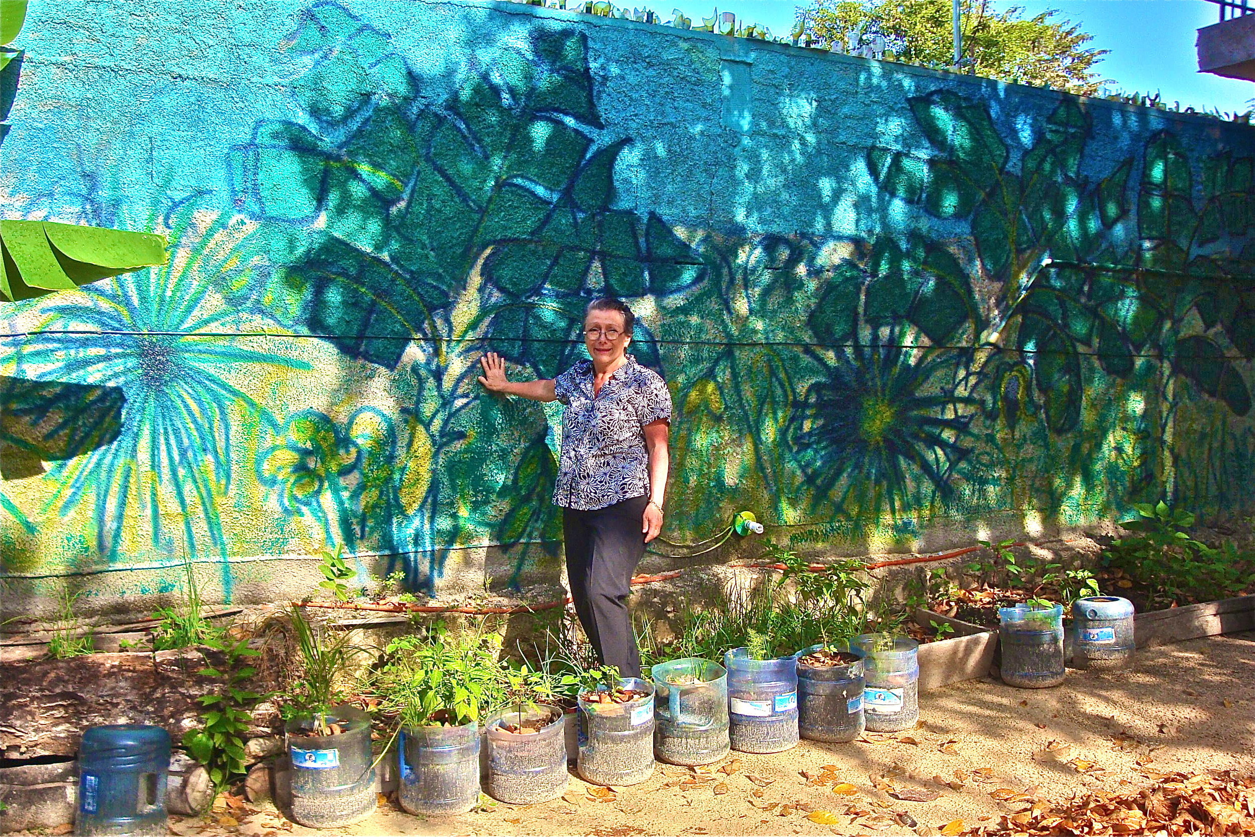 Artist and mural, MX, acrylic spray paint, 10' x 30'