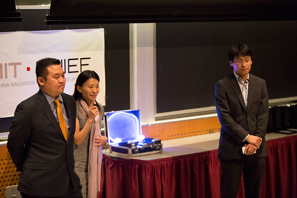  BelLEDs Technologies team members (left to right) Patrick Lin, Xiaolu Li, and Michael Chen deliver their pitch, complete with a working prototype of their smart LEDs (center, in the suitcase) that illuminated to the sound of music. 