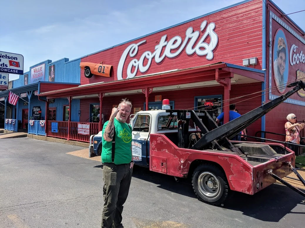 My husband John shows his appreciation for Cooter's Place — which, yes, was riiiight next to Willie Nelson's store and museum. At Willie's, you could buy tiny red headbands bearing braids made of brown yarn. You know, so that you can turn your infant into a miniature Willie Nelson. 