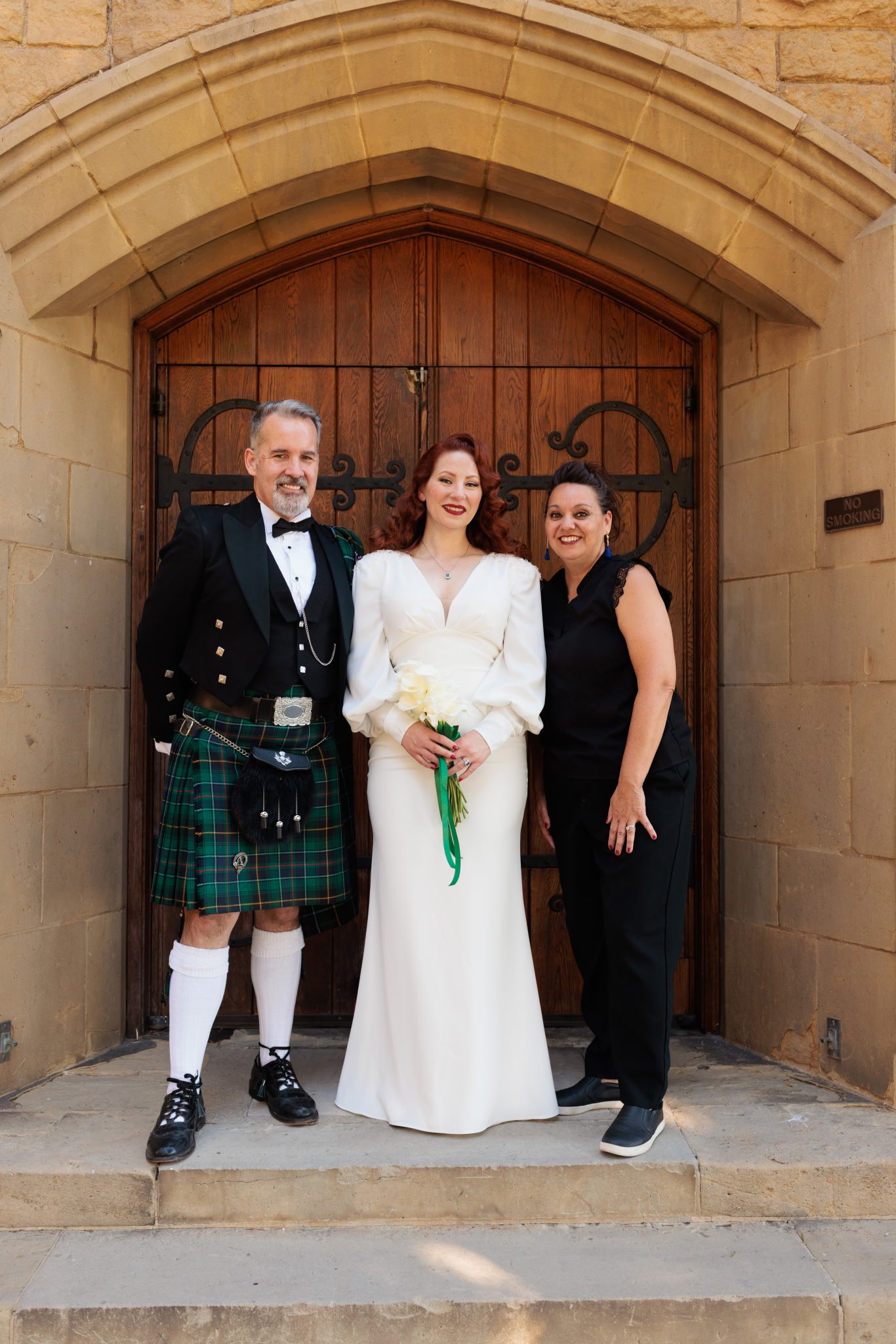 A classic Hollywood themed wedding. Ceremony at the Wee Kirk o the Heather in Glendale, CA. Couple posing with Event Planner, Libby Martin.