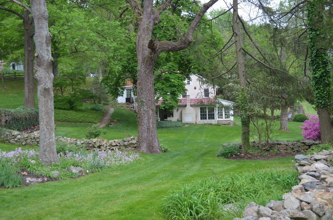 Our home with a peek of the vegetable garden