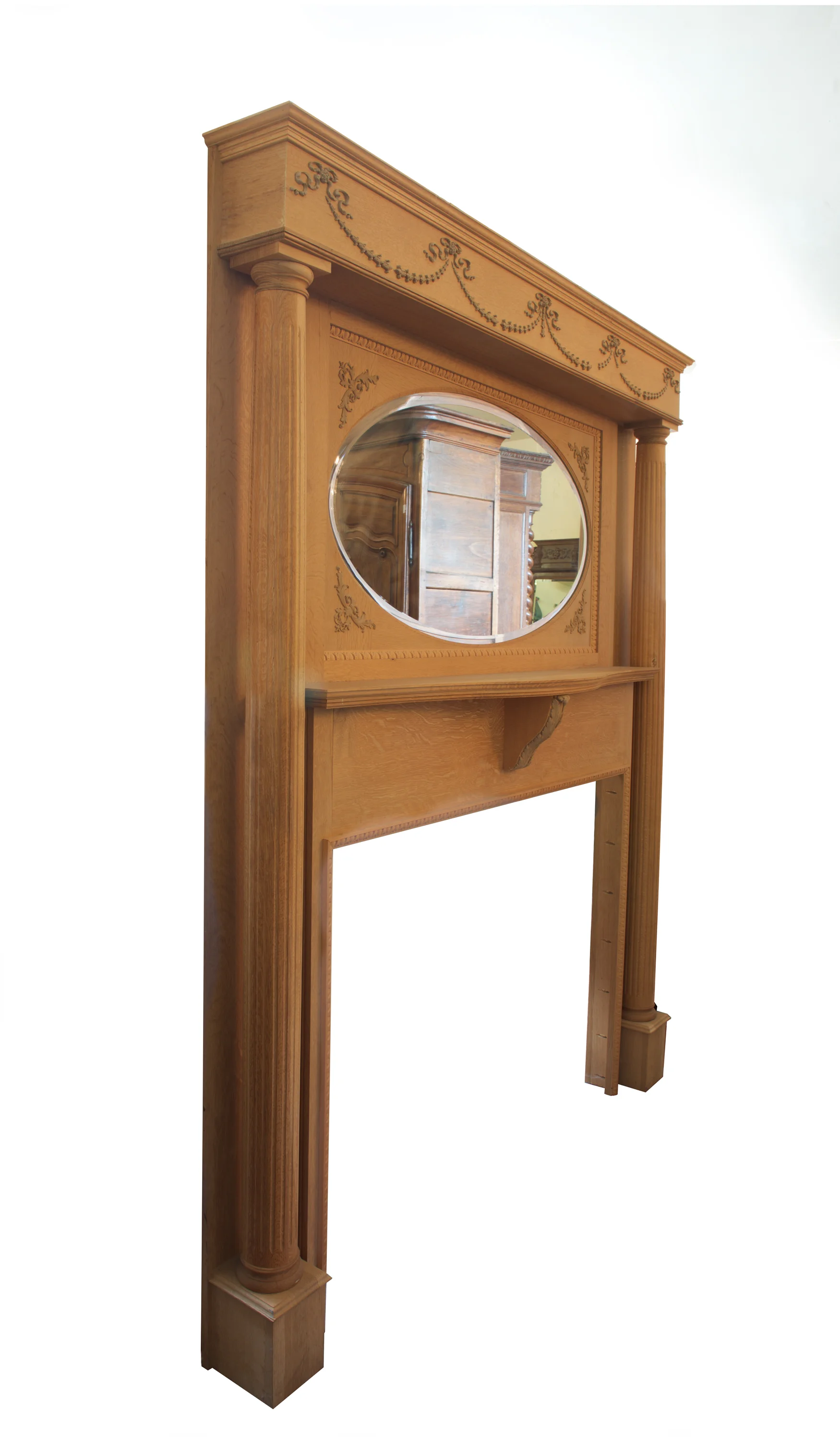 Quality made oak fireplace with carving and oval bevel mirror and fluted columns