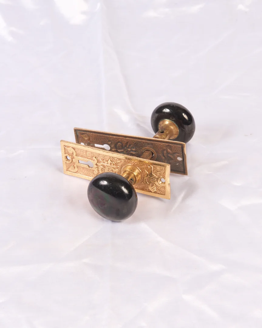 Black porcelain knobs with bronze plates