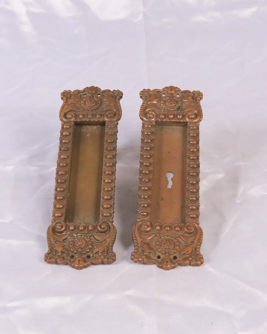 Pair of ornate cast bronze pocket door pulls