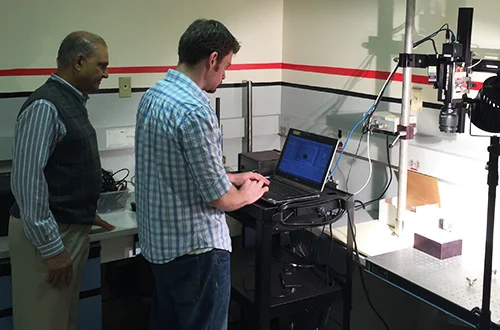 Dr. Trivedi (left) and Brimrose Research Engineer Sterling Walsh evaluate a culture sample using an acousto-optic tunable filter hyperspectral imager.