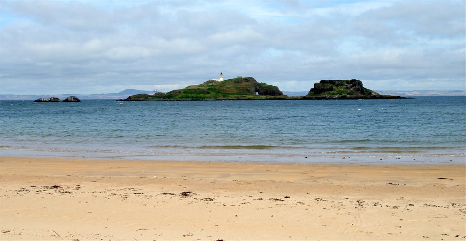 This is the Fidra Island and Lighthouse. The island's name is believed to be Old Norse in origin, referring to the large number of bird feathers found there. Like the nearby Bass Rock , it has a substantial seabird population, and is now an RSPB reserve. Robert Louis Stevenson often visited the beaches at the area known today as Yellowcraig and it is said that he based his map of Treasure Island on the shape of Fidra.