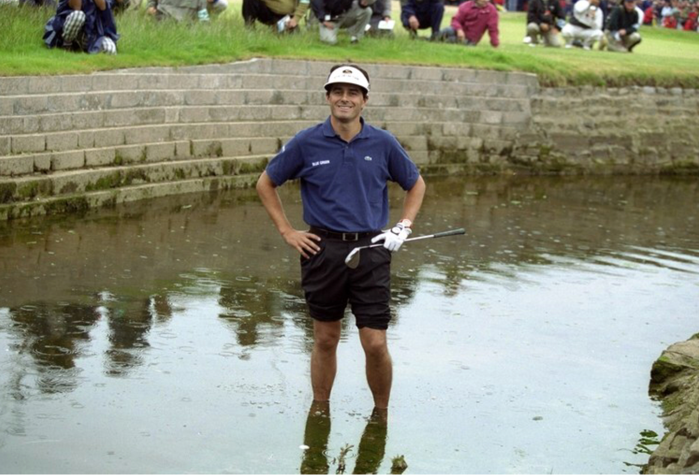 you idiot... The 1999 Championship, Carnoustie’s first since 1975, featured a climax so extraordinary, so unexpected, that it will never be forgotten. It resulted in Lawrie becoming the first Scotsman to win the Open on native soil for 68 years but also made Frenchman, Van de Velde, headline news all over the world. The records show that Lawrie, the first qualifier to win the Open since the R & A started to give exemptions in 1963, won the title after recording rounds of 73,74.76,67 and then beating Van de Velde and former champion, Justin Leonard, in a subsequent four hole play-off. However, what the bare facts don’t explain are the incredible scenes witnessed on the 72nd hole. To set the scene, Lawrie, then ranked 159th on the official World Rankings, had started the final round ten shots out of the lead. Despite a fine four under par 67, he was still three shots behind Van de Velde as the Frenchman mounted the last tee but, sensing something might happen, continued to practise his putting as a worldwide audience measured in millions watched in amazement as Van de Velde proceeded to implode. Lawrie deserves huge credit for the manner in which he played, both during the last round and in the resultant play-off but, in the end, he still could not have prevailed had it not been for Van de Velde perpetrating one of the biggest collapses in sporting history. Needing only a double bogey six on the final hole to become the first Frenchman to win the Open for 92 years, Van de Velde ran up a catastrophic triple bogey seven, even having to hole a brave 10-foot putt to get into the play-off. What transpired left the eloquent BBC golf commentator, Peter Alliss, almost lost for words. The Frenchman hit his drive right off the tee, finding dry land, albeit on a peninsula guarding the Barry Burn. From there, he could have hit wedge, wedge onto the green but, instead, elected to go for the green in two. Sadly for him, his second shot did not come off as he had envisaged. Instead, it hit the upper tier of a grandstand and rebounded into the deep rough. That was the start of Van de Velde’s problems. Next, the horrified gallery watched as his third shot came out softly and went into the burn in front of the green. After that, the episode became almost surreal. To begin with, the Frenchman chose to take off his shoes and roll up his trouser legs before jumping into the water to see if he could hit his submerged ball. Finally, as the water lapped around his ankles, sense prevailed. Van de Velde took a drop in the rough but then hit his fifth shot into the bunker guarding the right of the green. Under the circumstances, he displayed exemplary fortitude to blast his sixth shot out to ten feet and then hole the resultant putt. Click here to watch the 18th unfold. Sadly, though, Van de Velde’s chance to win the Claret Jug had gone. On the first play-off hole, clearly still in torment over what had happened ten minutes earlier, he hit his tee shot into a gorse bush leaving Lawrie and Leonard, the 1997 champion, to battle it out. In the end it was the unheralded Scotsman who prevailed. He moved into the lead when he holed a 12-foot birdie on the 17th, the third play-off hole, and then sealed his first major title when he hit his second shot to three feet for another birdie on the 18th.