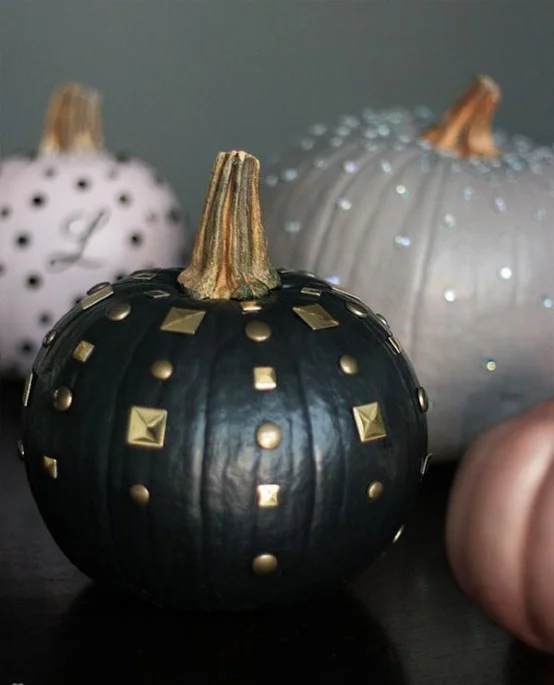 Use different materials to decorate your pumpkins. You can use tacks, sequins, glitter, metallic paints, nail heads, spikes, and pretty much anything you can glue or stick on to it.